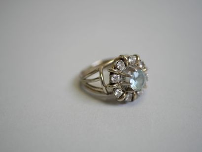 White gold ring set with a round blue stone**...