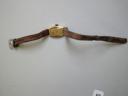 Ladies' gold watch on brown bracelet.
C 9.44...