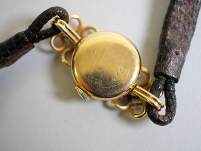Ladies' gold watch on black bracelet.
C 14.79...