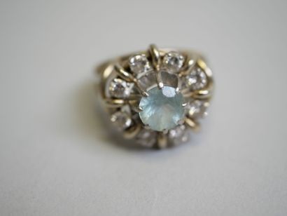 White gold ring set with a round blue stone**...