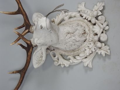 White lacquered resin stag head topped with...