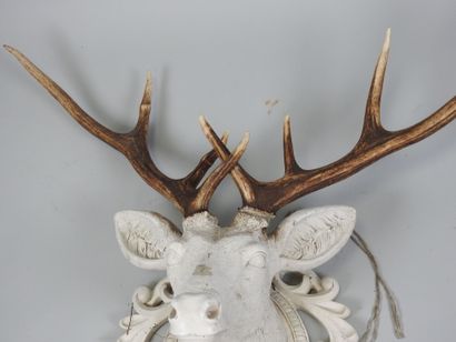 White lacquered resin stag head topped with...