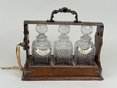 THE TANTALUS.
Wood and metal liquor cabinet...