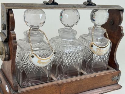 THE TANTALUS.
Wood and metal liquor cabinet...