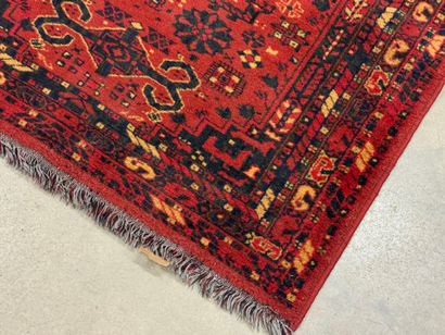 Hand-knotted wool rug with stylized motifs...