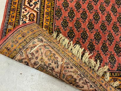 Hand-knotted wool rug with stylized motifs...