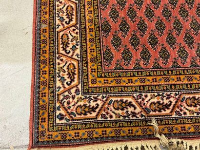 Hand-knotted wool rug with stylized motifs...
