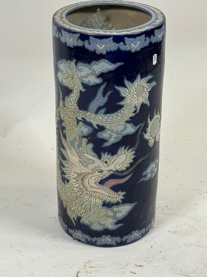 Circular ceramic umbrella stand on a blue...
