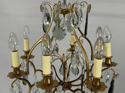 Brass chandelier with eight lights and crystal...