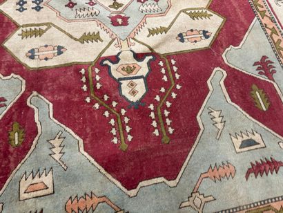 Large hand-knotted wool rug with stylized...