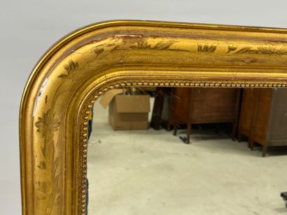 Wood and gilded stucco mirror decorated with...