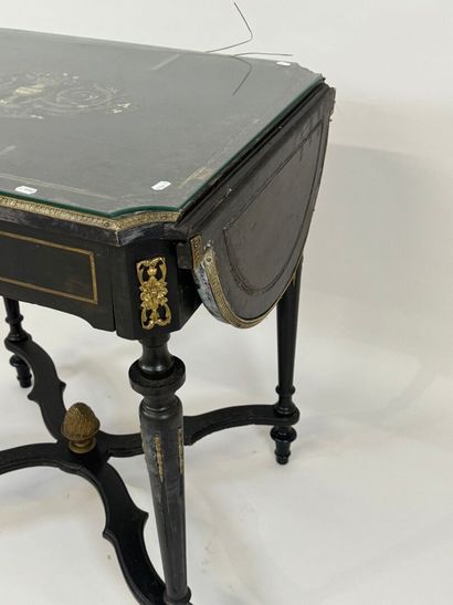 Middle table in blackened wood, opening with...
