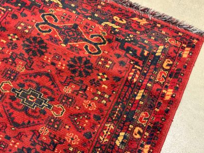Hand-knotted wool rug with stylized motifs...