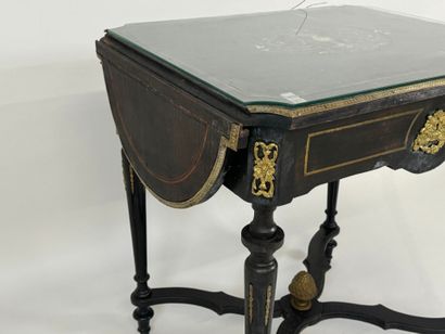 Middle table in blackened wood, opening with...