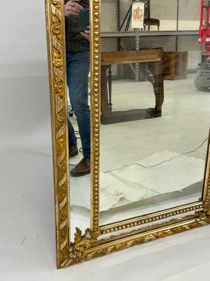Wood and gilded stucco glazed mirror decorated...