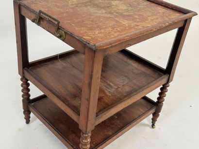 Small three-tier mahogany side table on casters.
49...