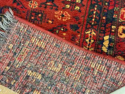 Hand-knotted wool rug with stylized motifs...