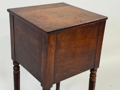 Turned wood bedside table opening with a...