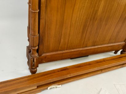 Carved wood bed decorated with basins and...