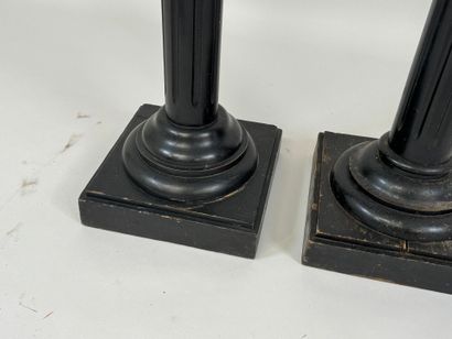 Two blackened wood saddles, fluted shaft,...