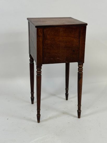 Turned wood bedside table opening with a...