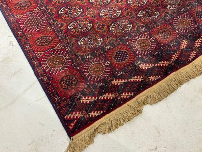 CHIRAZ.
Tapis mécanique sur fond rouge à...