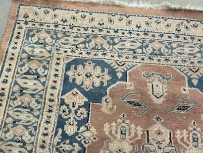 Hand-knotted wool rug with stylized motifs.
184...