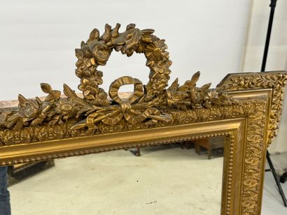 Wood and gilded stucco mirror decorated with...