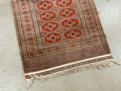 Hand-knotted wool rug with stylized motifs.
95...