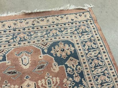 Hand-knotted wool rug with stylized motifs.
184...