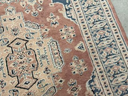 Hand-knotted wool rug with stylized motifs.
184...