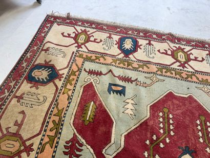 Large hand-knotted wool rug with stylized...