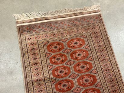 Hand-knotted wool rug with stylized motifs.
95...