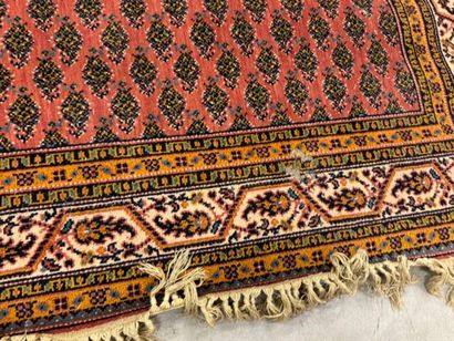 Hand-knotted wool rug with stylized motifs...