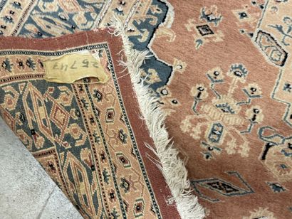 Hand-knotted wool rug with stylized motifs.
184...
