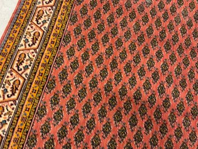 Hand-knotted wool rug with stylized motifs...