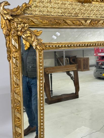Wood and gilded stucco glazed mirror decorated...
