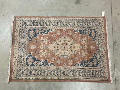Hand-knotted wool rug with stylized motifs.
184...