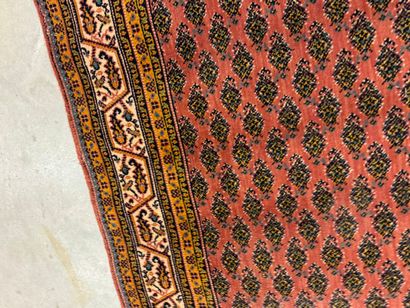 Hand-knotted wool rug with stylized motifs...