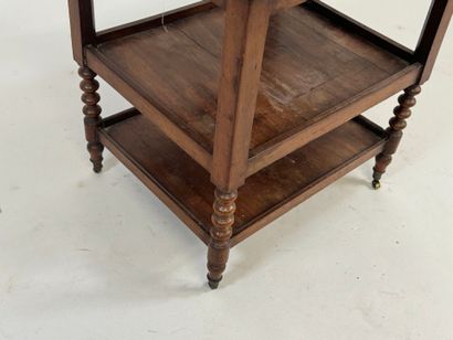 Small three-tier mahogany side table on casters.
49...