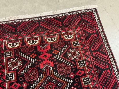 Hand-knotted wool rug with stylized motifs...