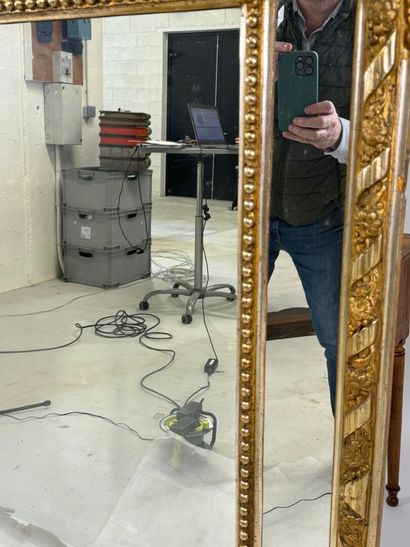 Wood and gilded stucco glazed mirror decorated...
