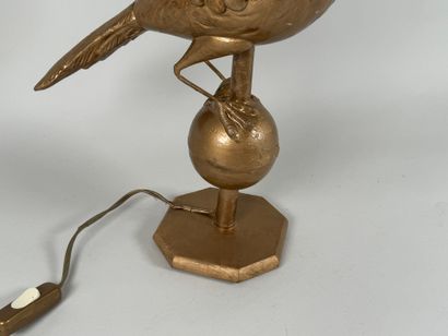 Gilded metal lamp base featuring a bird resting...