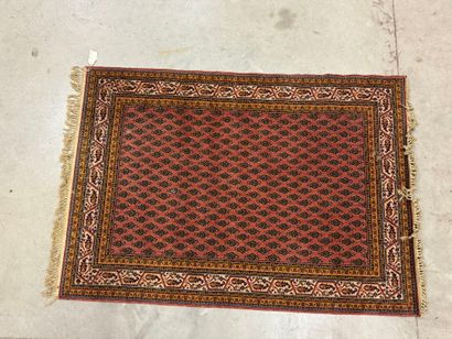 Hand-knotted wool rug with stylized motifs...