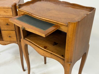 Two wooden bedside tables, one opening with...