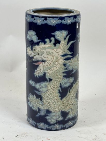Circular ceramic umbrella stand on a blue...