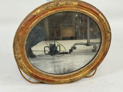 Oval wood and gilded stucco mirror decorated...