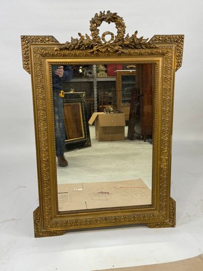 Wood and gilded stucco mirror decorated with...