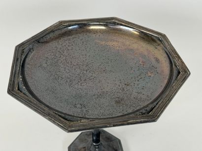 An octagonal bowl on a silver-plated metal...