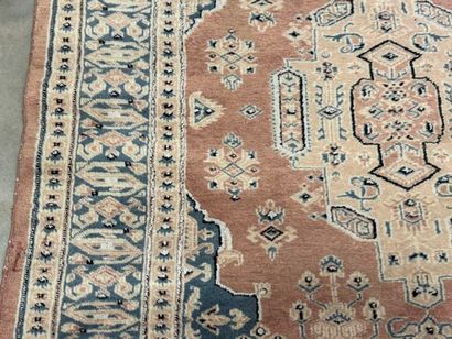 Hand-knotted wool rug with stylized motifs.
184...